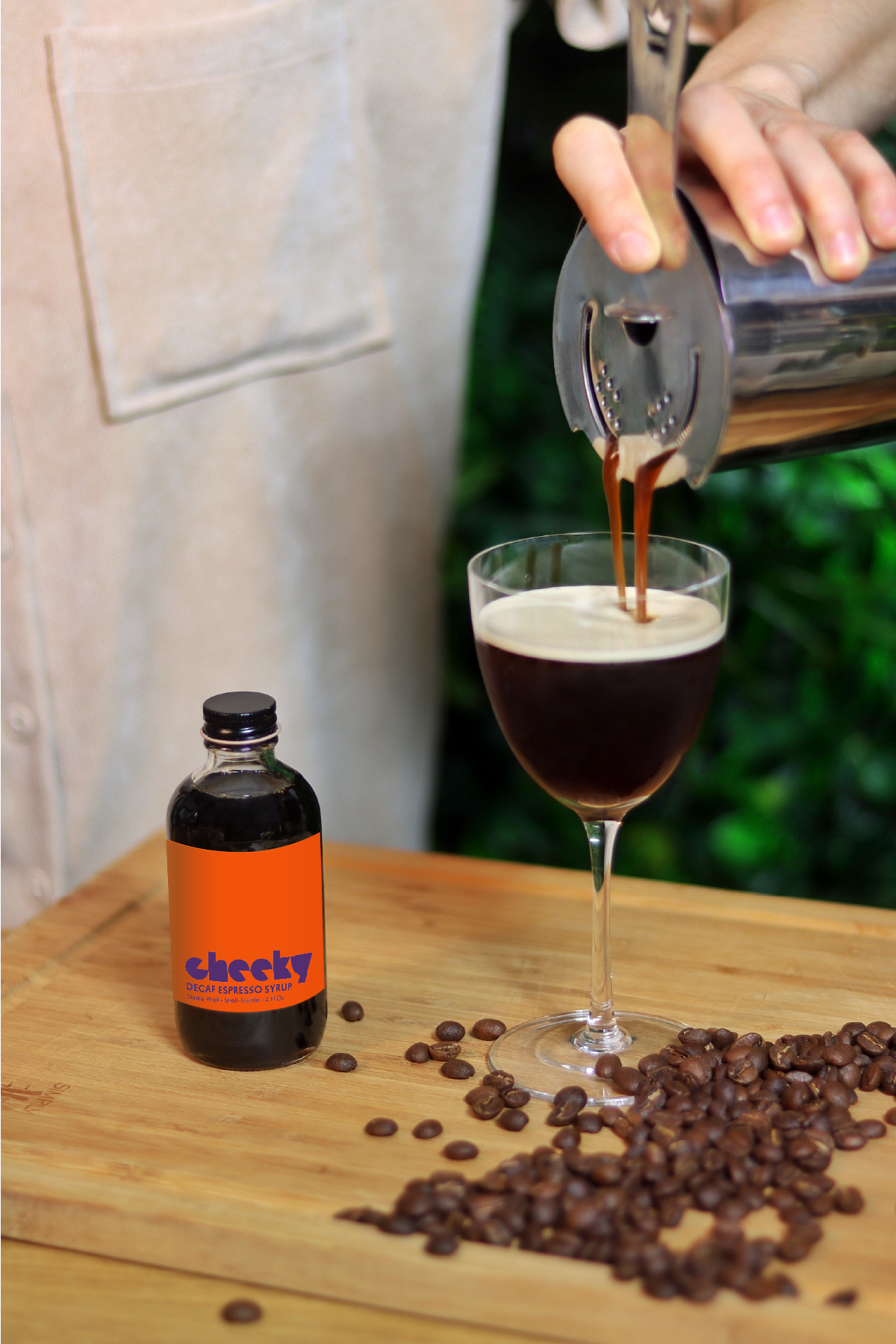 Woman pours espresso martini made with decaf espresso syrup by Cheeky Cocktails